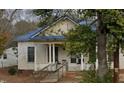 Charming home featuring a blue metal roof, classic columns, and potential for renovation at 915 S 3Rd St, Sanford, NC 27330