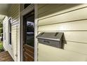 Close-up of the front door, mailbox, and yellow siding detail showcasing the entrance at 915 S 3Rd St, Sanford, NC 27330