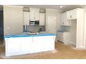 Modern kitchen with white cabinets, an island, and stainless steel appliances at 7315 Twin Pines Rd, Spring Hope, NC 27882