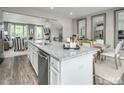 Open concept kitchen with white cabinets, granite island, and breakfast bar at 2103 Pitchfork Ln, Durham, NC 27713