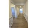Bright hallway with hardwood floors and neutral walls at 55 Sawtooth Oak Ln, Youngsville, NC 27596