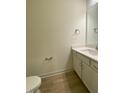 Small half bathroom with white vanity and a toilet at 55 Sawtooth Oak Ln, Youngsville, NC 27596