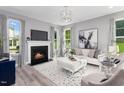 Bright living room showcasing a fireplace, ample natural light, and stylish decor at 609 Chopper Ln # Homesite 10, Durham, NC 27703