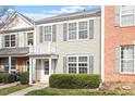 Two-story home featuring neutral siding, gray shutters, a small balcony and well-maintained landscaping at 610 Canyon Lake Cir, Morrisville, NC 27560