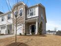 New townhome featuring varied siding, a well-manicured lawn, and a one car garage at 53 Lavender Ln, Clayton, NC 27520