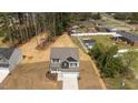 An aerial view of a beautiful two-story home with a large backyard and wooded surroundings at 60 Bennett Rd, Coats, NC 27521