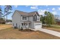 Beautiful two-story home featuring a two-car garage and manicured lawn at 60 Bennett Rd, Coats, NC 27521