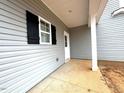Covered porch showcasing gray vinyl siding and white trim at 60 Bennett Rd, Coats, NC 27521