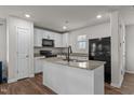 Modern kitchen with island, granite countertops, and stainless steel appliances at 918 E Green St # A102, Franklinton, NC 27525