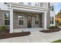 Inviting front entrance with a black door and brick accents at 11549 Helmond Way # 114, Raleigh, NC 27617
