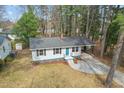An elevated view of a single-story house featuring a grey exterior, and a well-kept lawn at 320 Zollicoffer Ave, Henderson, NC 27536