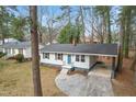 Aerial view of a cozy single-story house with a well-maintained yard, roof, and carport at 320 Zollicoffer Ave, Henderson, NC 27536