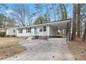 Well-maintained single-story house with a covered carport and landscaped front yard at 320 Zollicoffer Ave, Henderson, NC 27536
