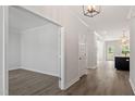 Bright entryway with hardwood floors, modern lighting, and an open floor plan leading to various rooms at 35 Accord Dr, Youngsville, NC 27596