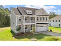 Charming two-story home featuring a covered porch, balcony, and a two-car garage in a desirable neighborhood at 35 Accord Dr, Youngsville, NC 27596