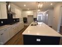 Modern kitchen featuring a large center island, stainless steel appliances, and custom cabinetry with sleek hardware at 35 Accord Dr, Youngsville, NC 27596
