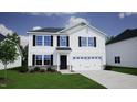 New two-story home showing a two car garage and stone accents with manicured lawn at 55 Calabria Ct, Franklinton, NC 27525