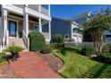 Landscaped front yard with a brick walkway leading to the house at 1509 Heritage Reserve Ct, Wake Forest, NC 27587