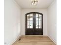 Bright entryway featuring wood floors, white walls, and a stylish light fixture at 201 Wash Hollow Dr, Wendell, NC 27591