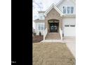Charming home featuring a brick entryway, a two-car garage, and a newly installed lawn at 201 Wash Hollow Dr, Wendell, NC 27591