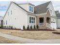 Charming home featuring light siding and a manicured lawn on a sunny day at 201 Wash Hollow Dr, Wendell, NC 27591