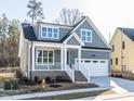 Charming gray home with a covered porch, white trim, and an attached two-car garage at 220 Big Bradley Dr, Wendell, NC 27591