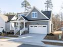 Charming gray home with a covered porch, white trim, and an attached two-car garage at 220 Big Bradley Dr, Wendell, NC 27591