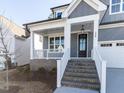 Close-up of the front porch with brick stairs, white railings, and a black front door at 220 Big Bradley Dr, Wendell, NC 27591