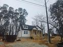 Newly built home with white siding, gray roof, and a front porch at 525 N Hoover Rd, Durham, NC 27703