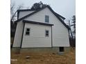 Rear view of the house showcasing the vinyl siding and window placement at 525 N Hoover Rd, Durham, NC 27703