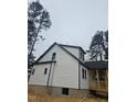 Side view of the house highlighting the vinyl siding, dormers, and porch at 525 N Hoover Rd, Durham, NC 27703