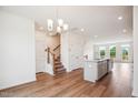 Modern kitchen with island, stainless steel appliances, and hardwood floors at 849 Parc Townes Dr # 11, Wendell, NC 27591