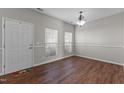 Inviting living room featuring wood floors, white walls, natural light, and front door at 821 Stackhurst Way, Wake Forest, NC 27587