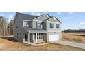 Charming two-story home featuring a gray exterior, a two-car garage, and a manicured front yard at 9184 Phoenix Ct, Spring Hope, NC 27882