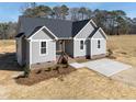 Attractive single-Gathering house with gray siding, a dark roof, and a freshly landscaped front yard at 9618 Stallings Rd, Spring Hope, NC 27882