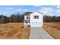 Two-story home with vinyl siding and attached garage on a sunny day at 9154 Phoenix Ct, Spring Hope, NC 27882