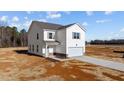 Two-story home with vinyl siding, attached garage, and new landscaping on a sunny day at 9154 Phoenix Ct, Spring Hope, NC 27882