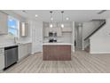 Modern kitchen featuring a center island, stainless steel appliances, and light gray cabinetry at 9154 Phoenix Ct, Spring Hope, NC 27882