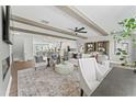 Open living space features stylish seating, exposed beams, and a view of the modern kitchen and dining areas at 10529 Pleasant Branch Dr # 201, Raleigh, NC 27614