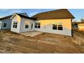 Exterior showcasing the back of the house, featuring a patio space and gray vinyl siding at 1064 Fairhaven Dr # 95, Mebane, NC 27302