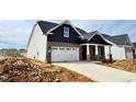 New two-story home boasting a modern design, two-car garage, and a well-lit entrance at 1064 Fairhaven Dr # 95, Mebane, NC 27302