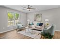 Bright living room featuring stylish furniture and a large window at 132 Prairie Dog Dr, Louisburg, NC 27549