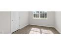 Sunlit bedroom featuring hardwood floors, a window, and neutral walls at 1688 Abberly Pl, Graham, NC 27253