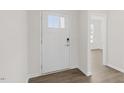 Clean, bright entryway featuring hardwood floors and a white front door with glass panel at 1688 Abberly Pl, Graham, NC 27253