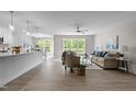 Bright open-concept living space with modern décor, wood floors, and a view of the backyard at 200 Rawhide Dr, Louisburg, NC 27549