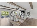 Bright living room boasts neutral tones, beamed ceilings, fireplace, and a large balcony overlooking greenery at 10535 Pleasant Branch Dr # 201, Raleigh, NC 27614
