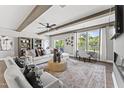 Elegant living room featuring neutral decor, beamed ceilings, large windows, and a cozy work nook at 10535 Pleasant Branch Dr # 201, Raleigh, NC 27614