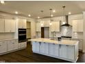 Bright, newly renovated kitchen with stainless steel appliances, quartz countertops, and modern cabinetry at 1600 Maelyn Way, Fuquay Varina, NC 27526