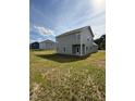 View of the home's rear exterior showing the siding, windows and backyard space at 178 Vili Dr, Broadway, NC 27505