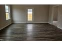 Bright living room with a window and back door features hardwood flooring and neutral walls at 178 Vili Dr, Broadway, NC 27505